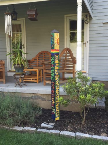 sun-and-earth-peace-pole-in-garden-pw